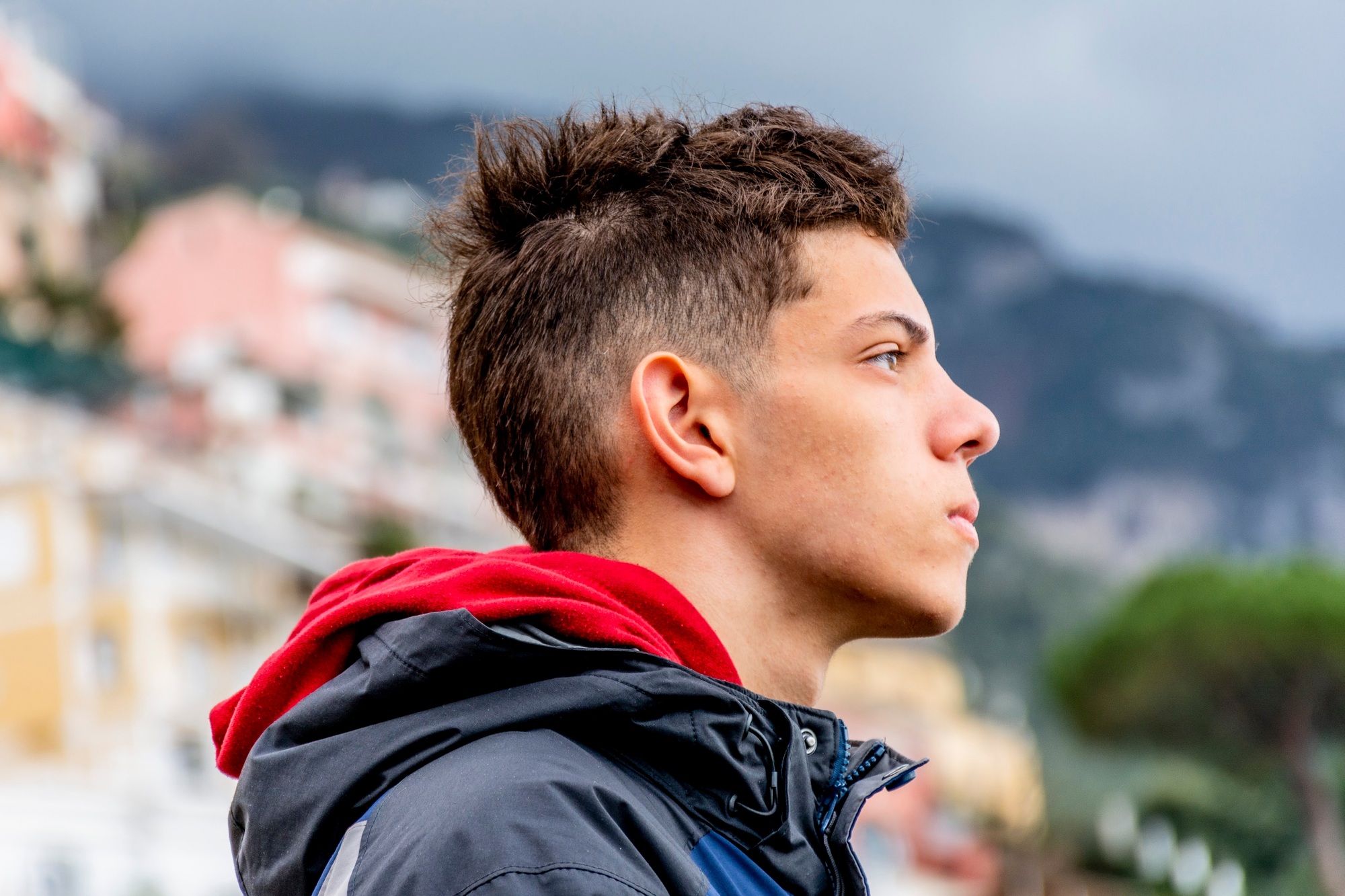 Teenager in front of a blurred Positano